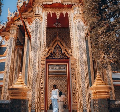 man and woman standing in front of brown concrete building during daytime